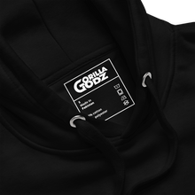 Load image into Gallery viewer, Gorilla Godz &quot;Manifest Success&quot; hoodie tag showing care instructions and fabric details.
